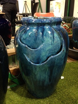 Picture of a turquoise glazed self contained fountain. 
