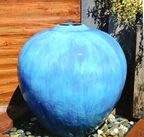 Picture of an outdoor globe style self contained fountain in teal. 