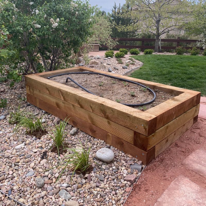 A sturdy constructed custom raised planet bed for vegetables and strawberries in Arvada, Colorado. 
