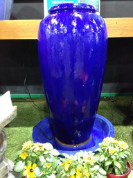 Picture of a cobalt blue jar fountain. 