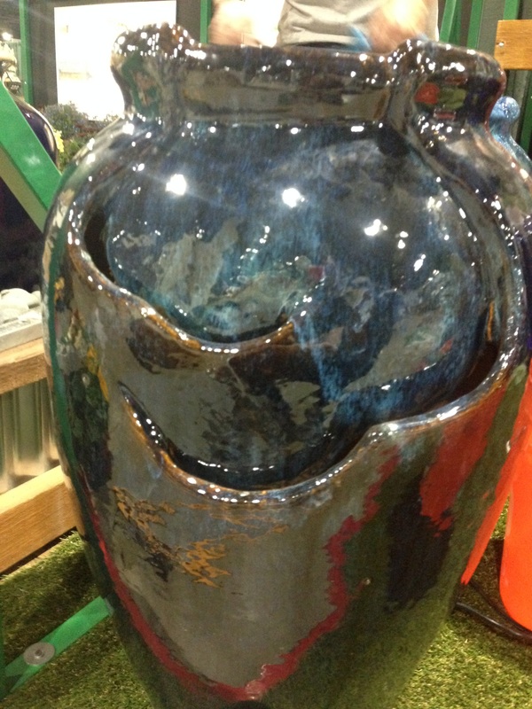 Picture of an earth toned indoor/outdoor self contained fountain in earth tone glaze. 