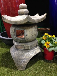 Picture of an Asian inspired self contained jar fountain. 