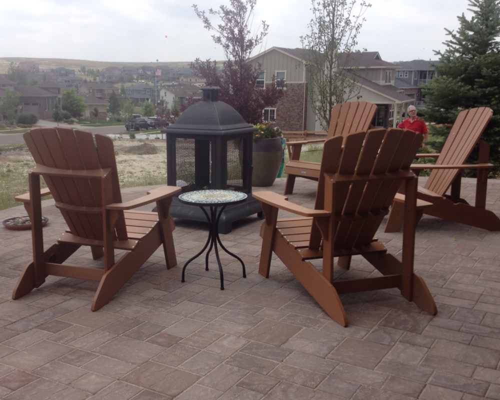Metal style wood burning outdoor fire pit on patio in the Denver metro.