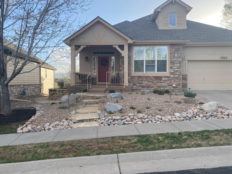 Rustic xeriscape design for a front yard in Arvada, Colorado with a silom stone walkway, plant selection, outdoor LED lighting system, and drought tolerant riverstone ground covering. 