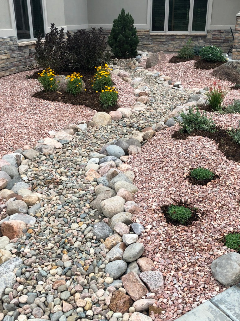 Custom drought tolerant pollinator gardens include ground covering, drip irrigation and plant selection with shrubs and ecologically appropriate flowers in Colorado's Front Range. 